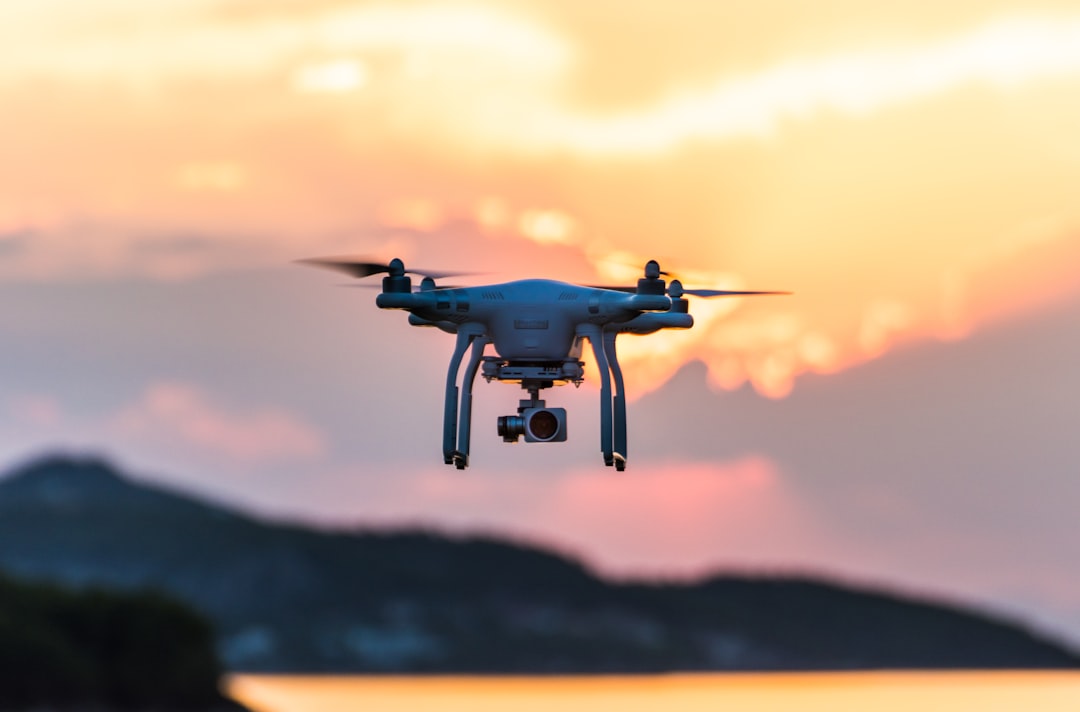 white quad-copter drone during golden hour - Photo by Jason Mavrommatis on Unsplash